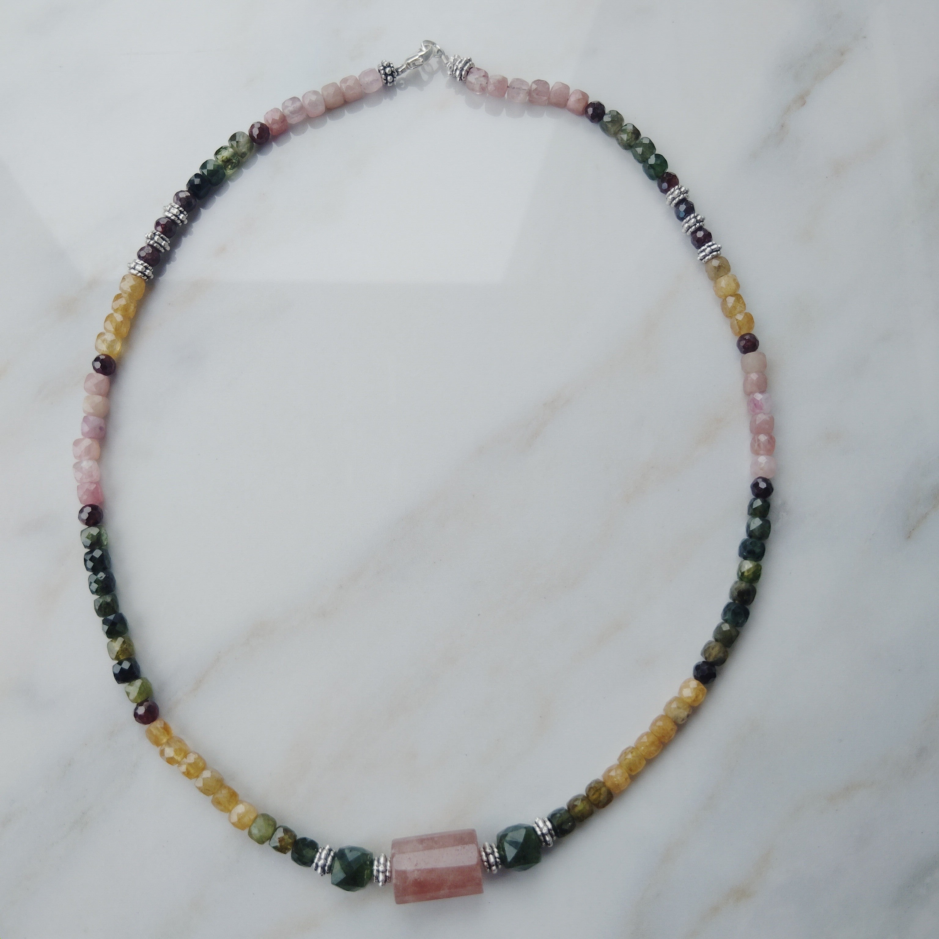 Handcrafted tourmaline necklace with a strawberry quartz and jade center beads. 925 Sterling silver clasp.