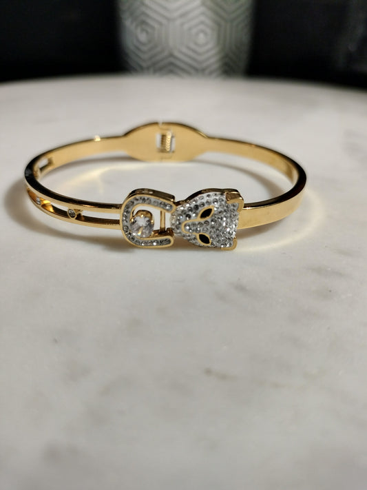 Gold plated stainless steel cubic zirconia lion head bracelet.