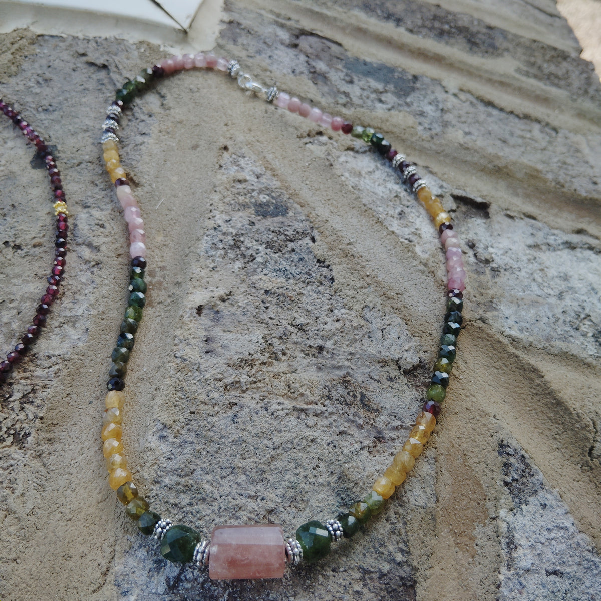 Handcrafted tourmaline necklace with a strawberry quartz and jade center beads. 925 Sterling silver clasp.