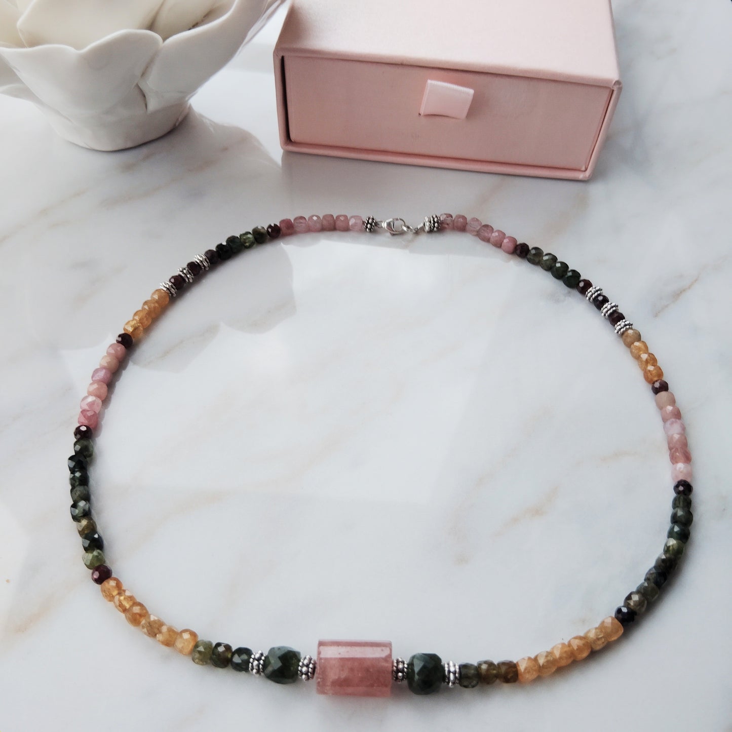Handcrafted tourmaline necklace with a strawberry quartz and jade center beads. 925 Sterling silver clasp.