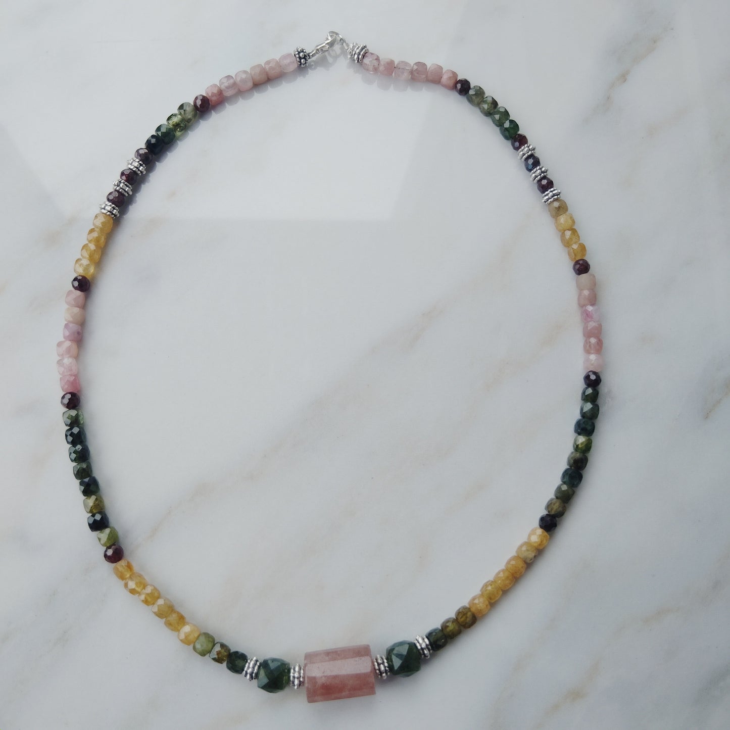 Handcrafted tourmaline necklace with a strawberry quartz and jade center beads. 925 Sterling silver clasp.